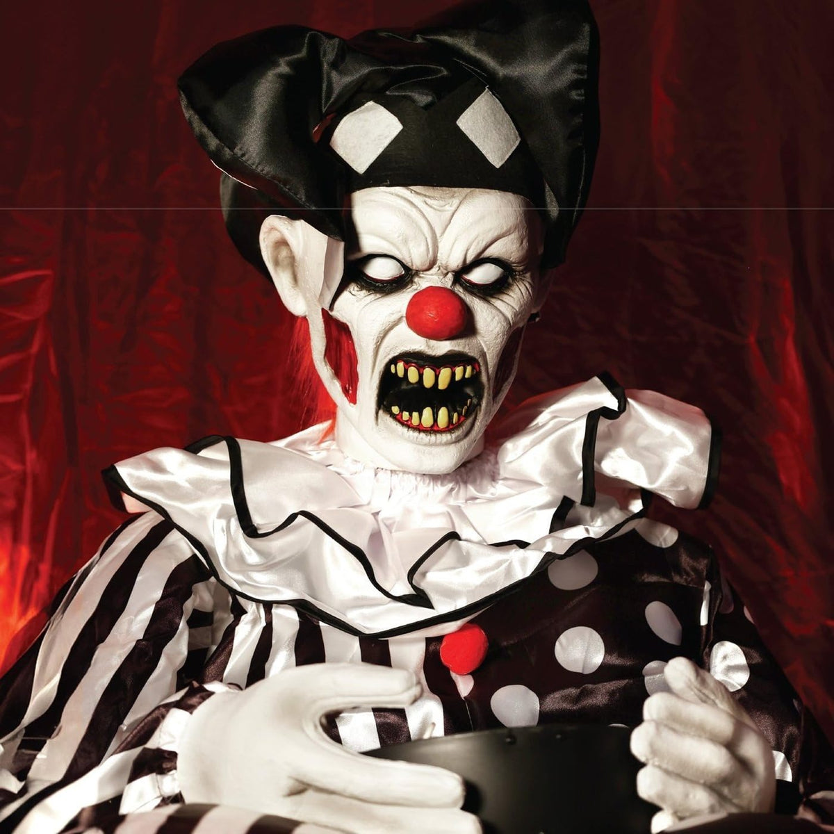 Close up of the clown face, white eyes and yellow teeth